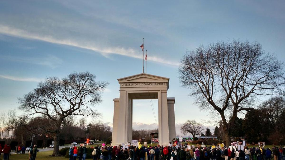 People gather at Peace Arch Park on Sunday, Jan. 29, to protest an executive order temporarily banning travel into the U.S. by people from seven Muslim-majority countries.