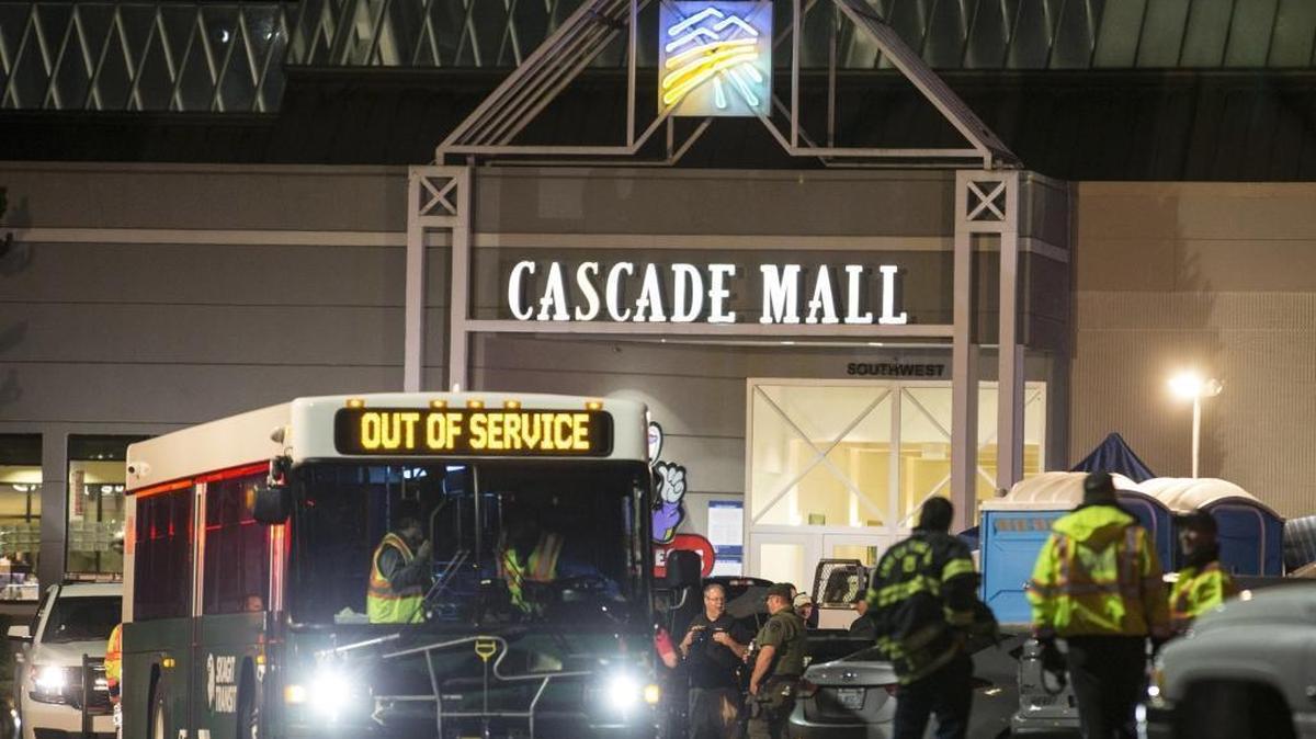 Emergency personnel stand in front of an entrance to the Cascade Mall at the scene of a shooting where five people were killed Friday, Sept. 23, 2016, in Burlington, Wash.