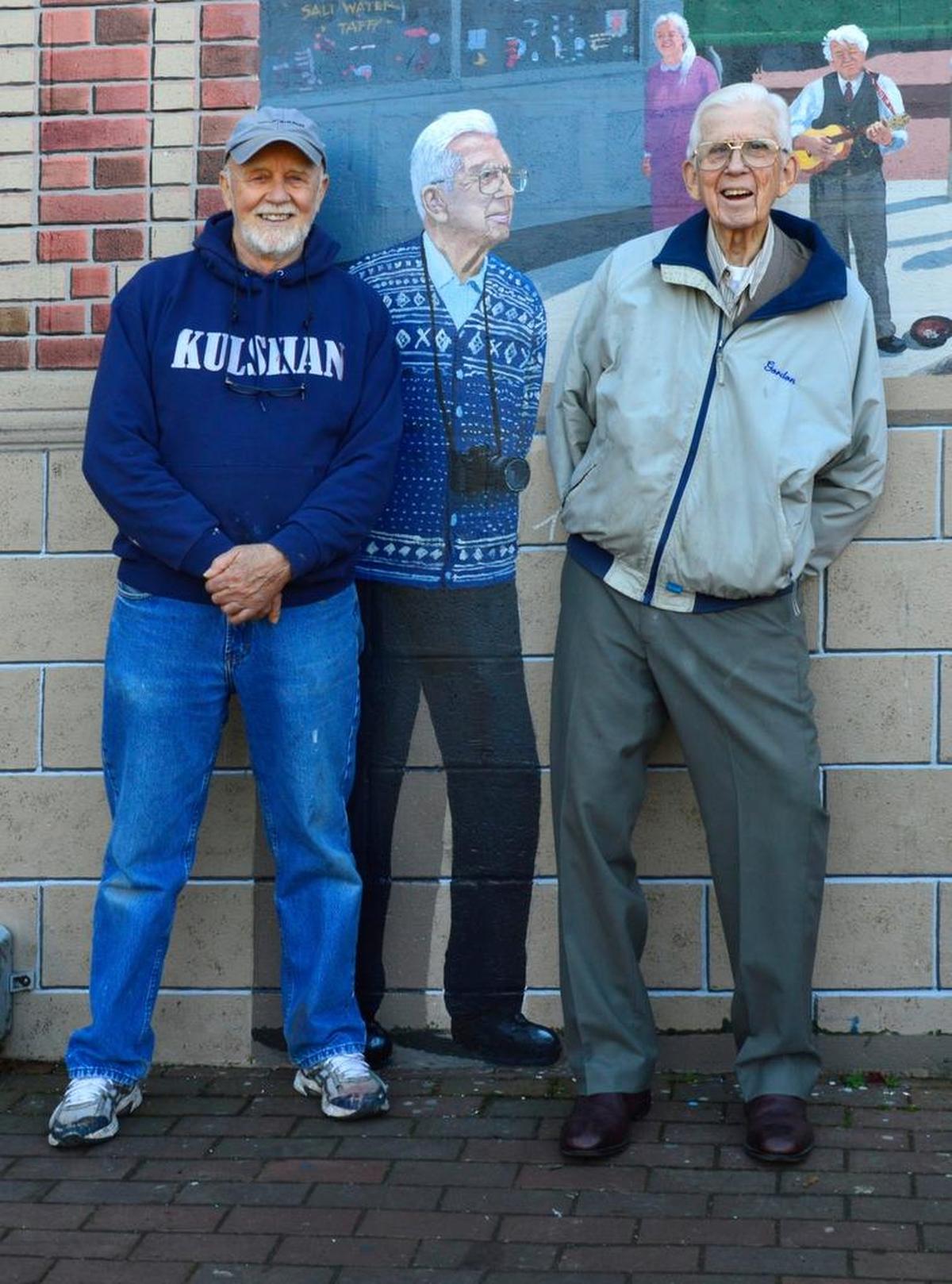 In 2013, Bellingham painter Lanny Little, left, added Gordon Tweit to the outdoor mural that Little had painted 13 years earlier at Fairhaven Village Green. Little later turned to videography and produced a 20-minute documentary about Tweit, called “Gordie’s World.”