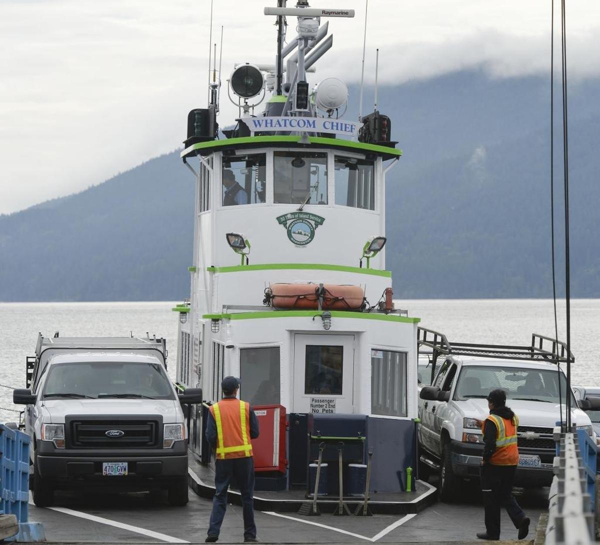 The Whatcom Chief ferry, with a new paint job similar to the Seahawks colors, prepares to offload vehicles from Lummi Island at Gooseberry Point in September 2014. The ferry is now in dry dock, meaning only a foot ferry is available to take people to the island until Oct. 1.
