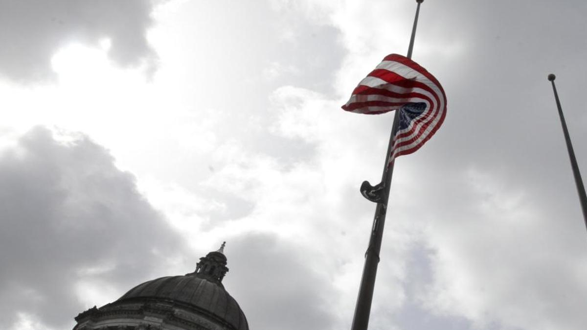 
The flags in front of the Legislative Building in Olympia are lowered.
