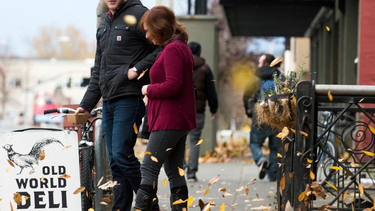 Caleb Hazel, left, and his mother Judy Hazel walk onto the sidewalk along North State Street after lunch on a blustery Thursday afternoon, Nov. 12, in Bellingham.