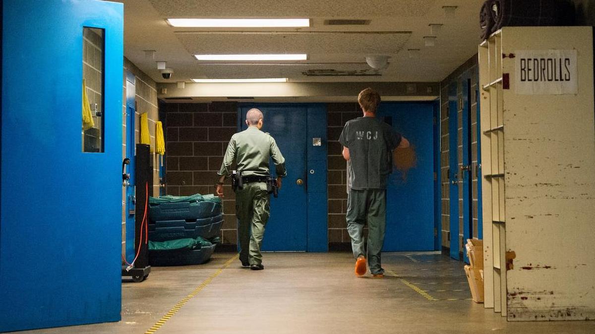 
A deputy escorts an inmate to a minimum security housing area on Saturday, July 4, at the Whatcom County Jail in Bellingham, Wash.
