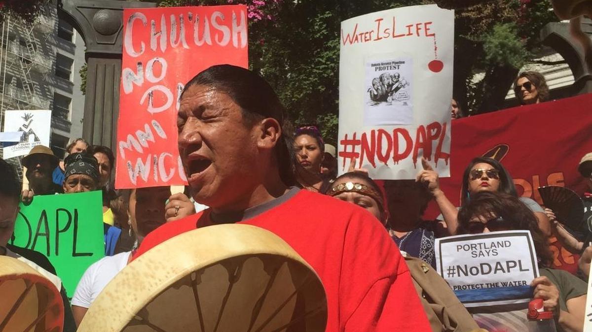 Joseph Phillips Sr., a member of the Manto Sipi Nation, drums and chants as he joins other protestors in downtown Portland, Ore., Friday, Sept. 9, 2016, as a show of solidarity with protesters in other states trying to halt the construction of the Dakota Access Pipeline that will move oil from North Dakota to Illinois. A federal judge in Washington on Friday, Sept. 9, 2016, denied an attempt by the Standing Rock Sioux tribe to halt construction of a disputed oil pipeline that passes near its reservation in North Dakota.