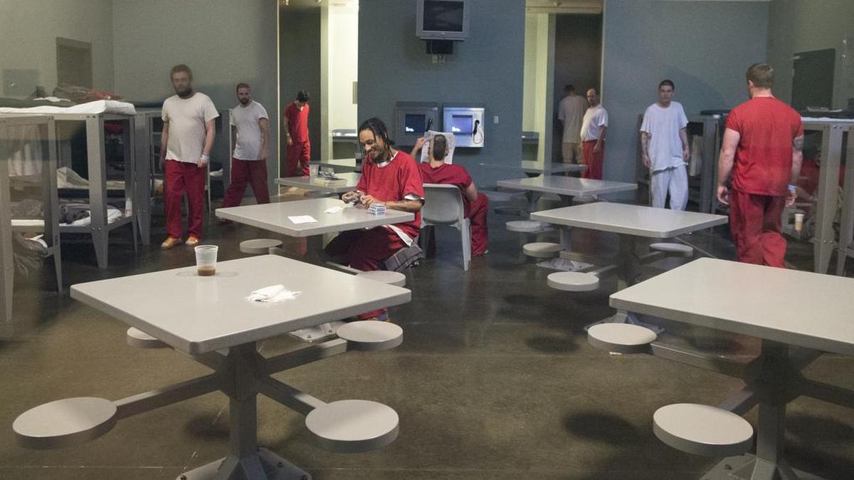 
Minimum security inmates read, play cards and walk around a 32-person housing unit at Whatcom County Jail’s Interim Work Center on June 30 in Bellingham.

