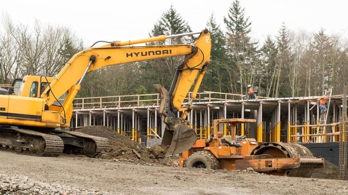 Construction crews work on a new Holiday Inn across the street from Bellingham International Airport on Friday, Jan. 15, in Bellingham. The 153-room hotel is expected to be completed later this year.