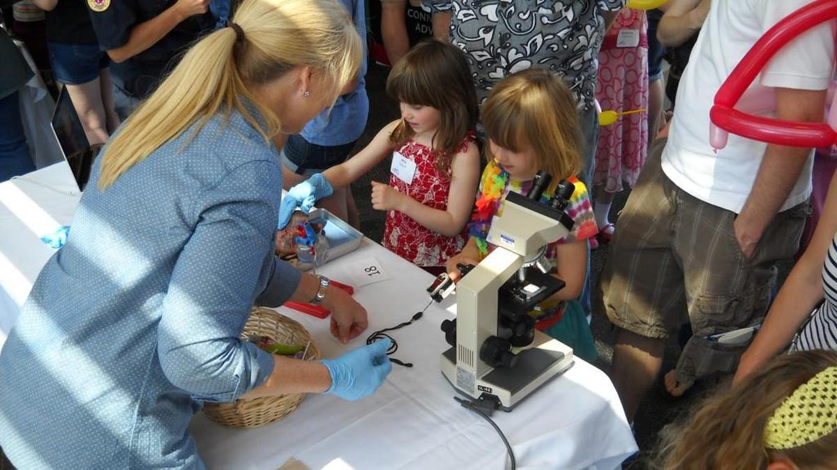 Girls learn about microscopes during the 2015 GEMS Fair at Western Washington University.