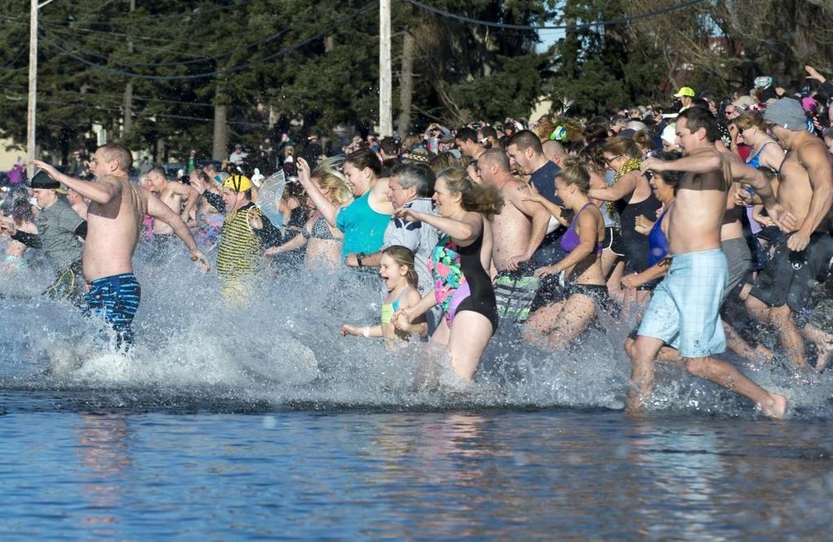 Hundreds of people run into the water at Birch Bay during the 2016 Birch Bay Polar Bear Plunge on Friday, Jan. 1.