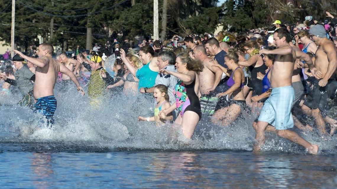 Hundreds of people run into the water at Birch Bay in northern Washington during the Birch Bay Polar Bear Plunge on, Jan. 1, 2016.