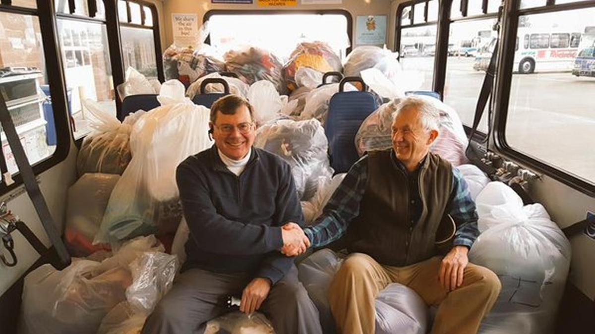 Amalgamated Transit Union President Mark Lowry and Whatcom Transportation Authority General Manager Pete Stark are surrounded by bags of donated clothes and blankets collected in December 2015 during the two agencies’ “Warm Hearts Warm Hands” drive. People donated 2 tons of items to help local people in need.
