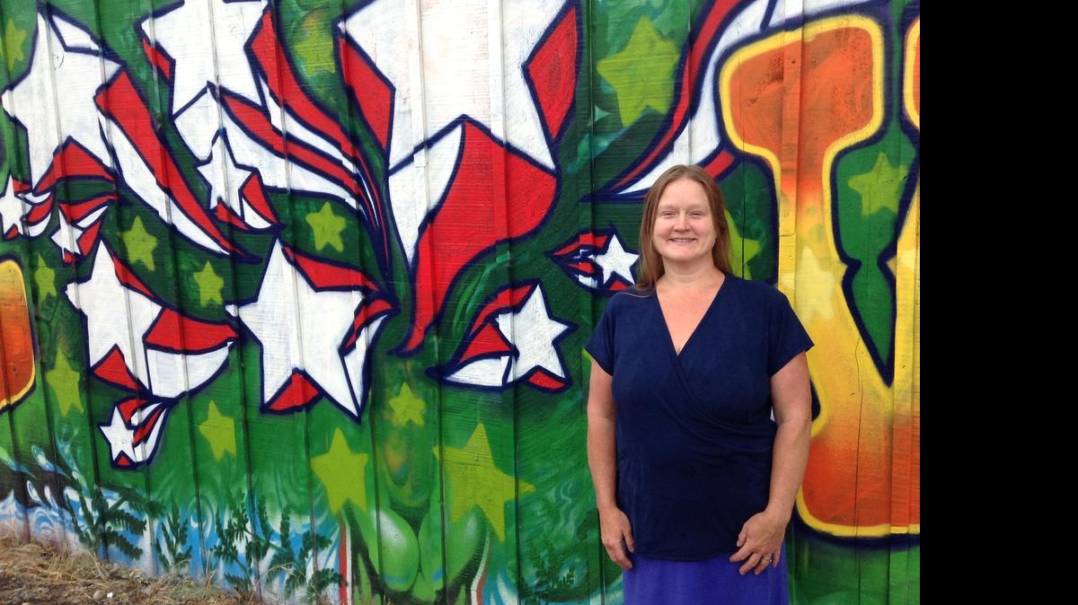 
Vicca Thompson, who is running for Ferndale mayor, stands in front of a “Vote Vicca” sign spray-painted on the side of her store, The Grow Shop, on Monday, July 13, 2015.

