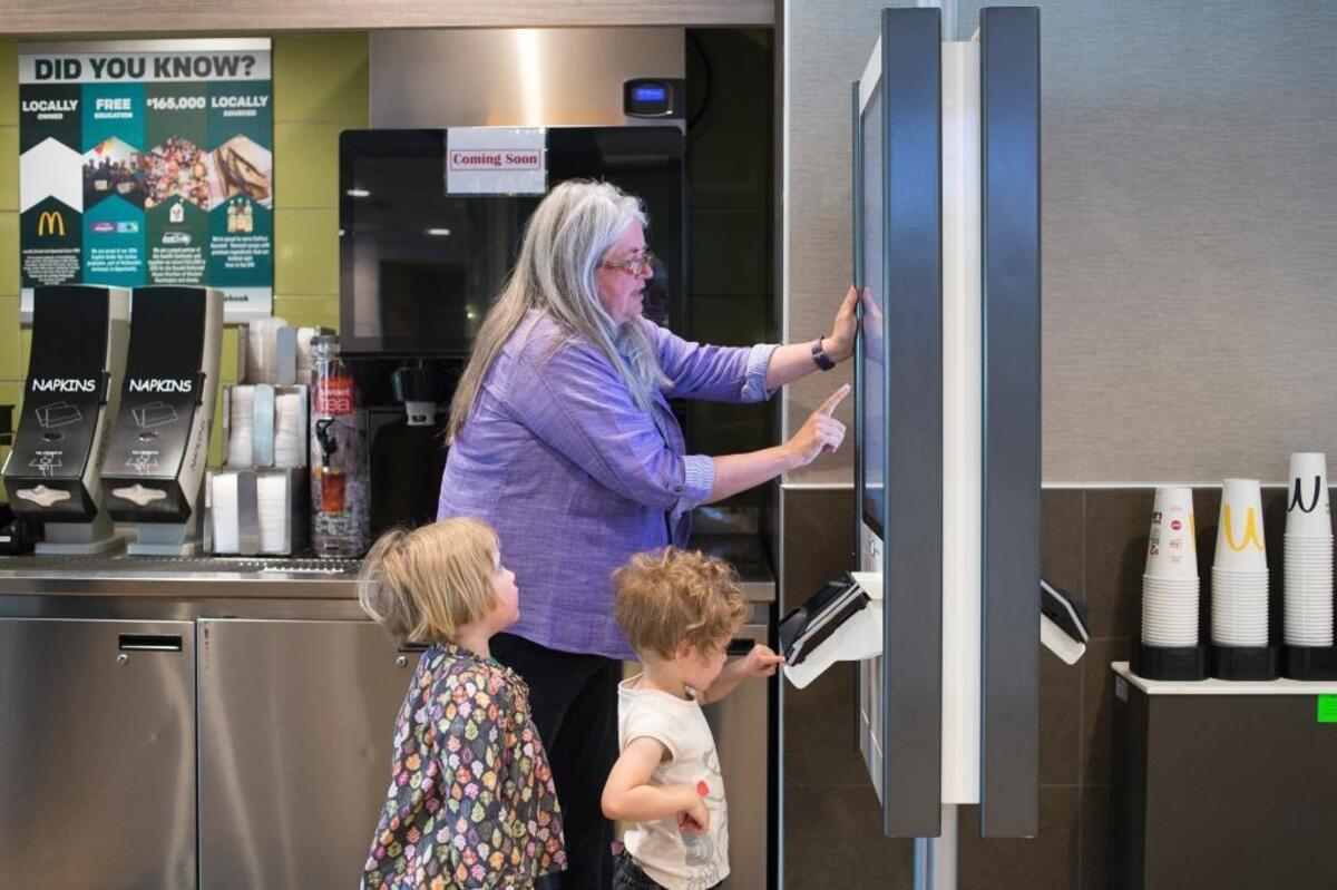 Bev Wiltshire and her grandchildren Cora Schrengohst, right, and Betty Schrengohst, left, try out a new ordering kiosk at McDonald's on Telegraph Road Thursday, June 1, in Bellingham.