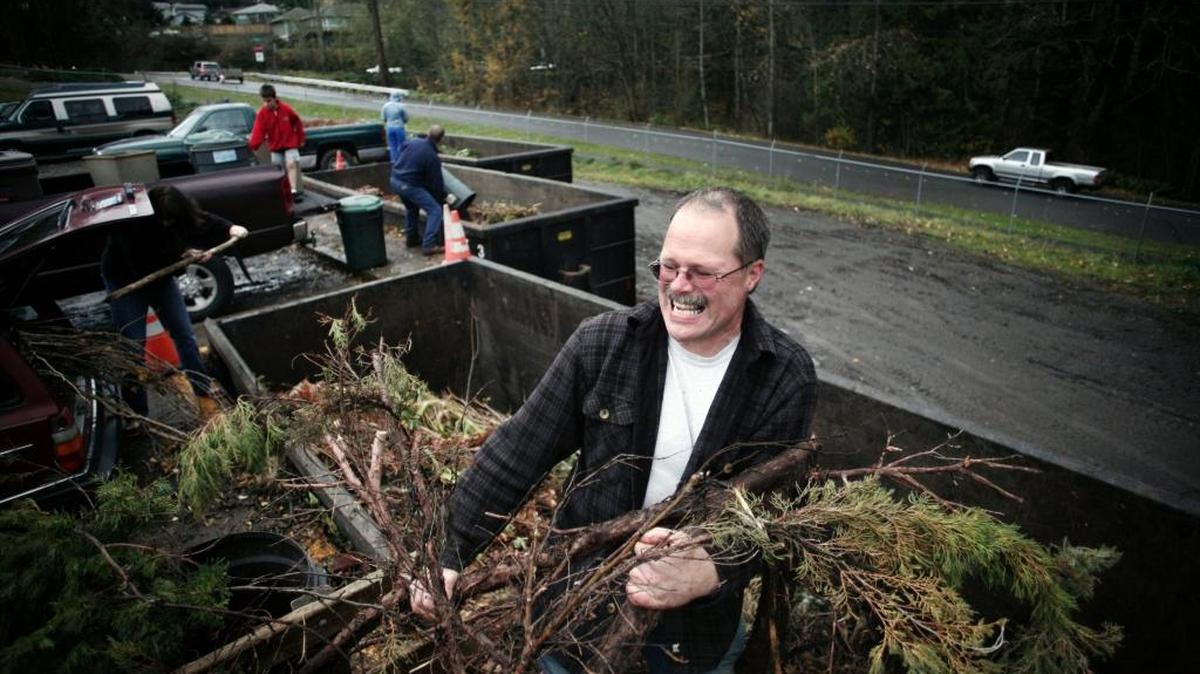 John Hatten of Bellingham dumps hedges from his trailer at the Clean Green Transfer Station on Woburn Street and Lakeway Drive in Bellingham in this file photo from Nov. 15, 2009. The City Council is considering cutting Clean Green, which Bellingham and Whatcom County started in 1989.