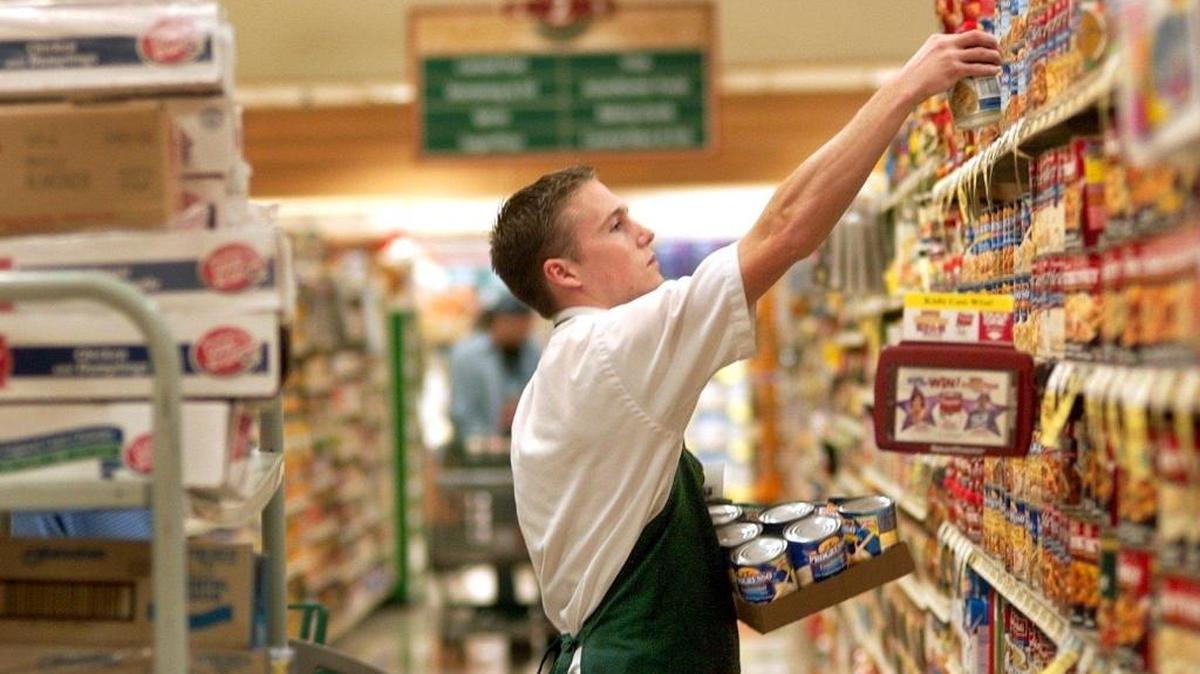 Jonathan Cooper stocks canned foods at the Haggen store in Barkley Village in this 2003 photo. The longtime Bellingham grocer plans to auction off its cores stores, including the Barkley Village store, on Feb. 11, 2016 in New York.