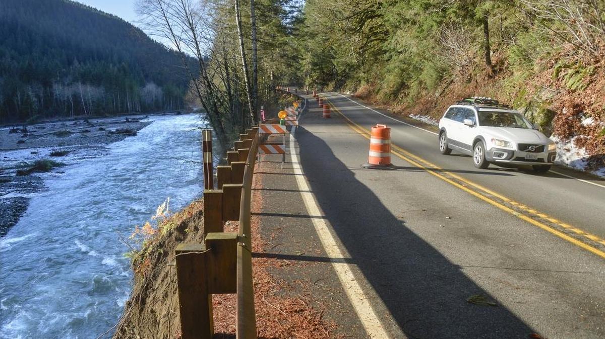 A car heads up the Mount Baker Highway east of Glacier on Thursday, Nov. 19, 2015, where the Nooksack River washed out the bank and undermined the road. The road will be down to one lane as road crews make emergency repairs.