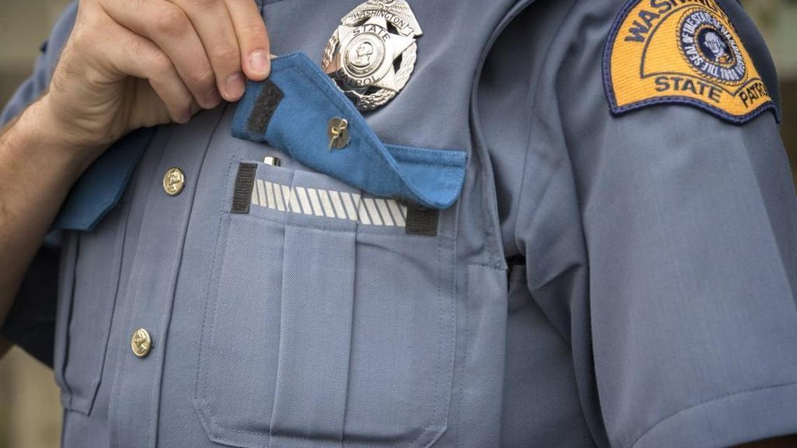 Trooper Schearer shows off one of the new uniform’s features: a velcro front pocket.