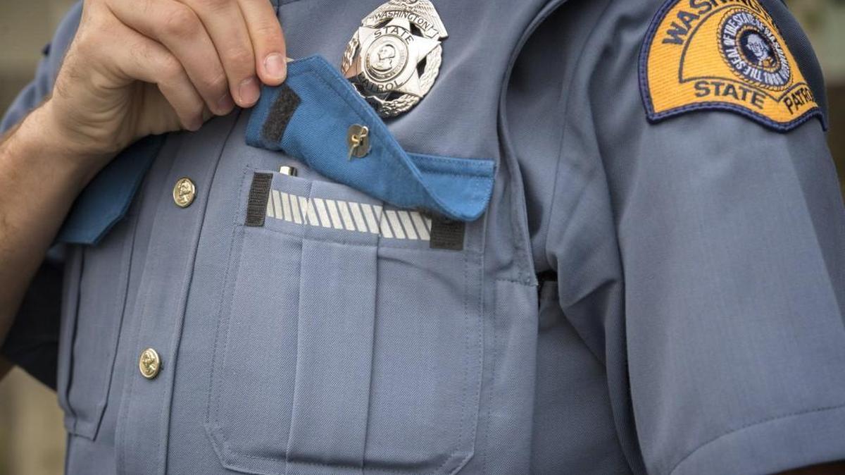 Trooper Schearer shows off one of the new uniform’s features: a velcro front pocket.