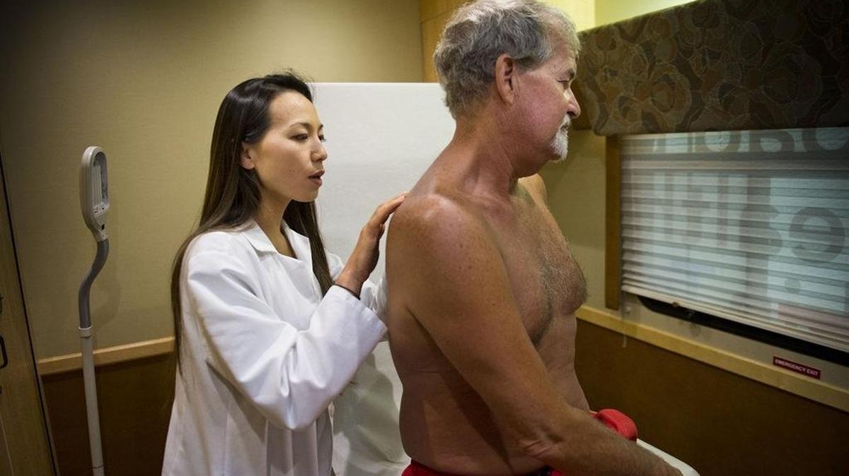 Dermatologist Linda Sheu checks Greg Fletcher of Elk Grove, Calif., as she volunteers for a free skin cancer clinic on Aug. 12, 2014. PeaceHealth St. Joseph Cancer Center in Bellingham will offer free screenings Saturday, April 30, to 50 people who sign up in advance.