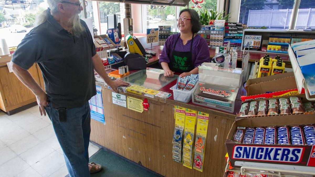 
Neighbor Ray Martin, owner of American Antiques, visits with Giffords Market owner Sung Mun on Monday morning, Aug. 24 2015, at the Bellingham mini-mart on Elm Street. The store is closing Aug. 31 to make way for a brewery.
