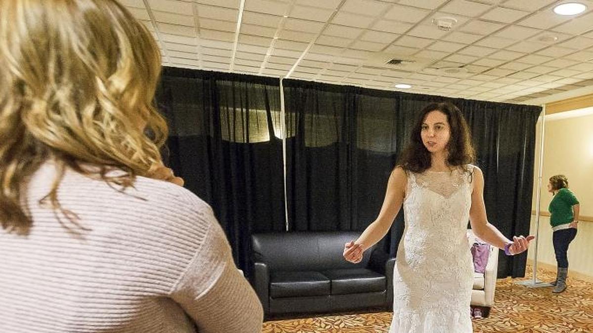 Rebekah Morgan of Glacier tries on a Justin Alexander wedding dress while seeking advice from her mother, Kathy Morgan, left, and friend Shawna McKay during the Bridal Inspirations Wedding Expo & Fashion Show, held January 2016 at Four Points By Sheraton Bellingham Hotel & Conference Center. The 2017 expo will be Jan. 21, also at Four Points.