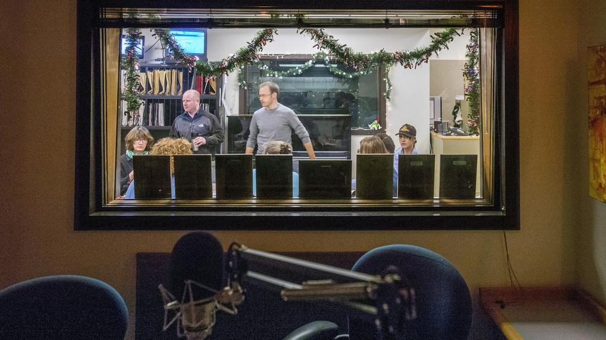 The news staff’s morning meeting as seen from a broadcast studio in the Seattle offices of KPLU, Dec. 21, 2015.