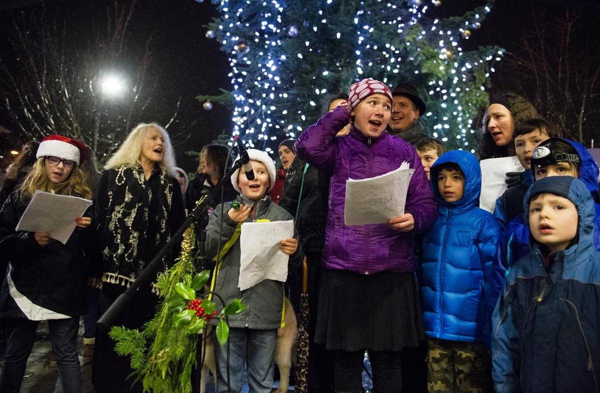 Kids and adults from Wild Hare Music School sing Christmas carols during the Bellingham Tree Lighting Ceremony at Depot Market Square in this file photo.