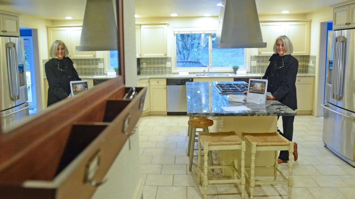 Realtor Lylene Johnson, of Johnson Team Real Estate, checks out the kitchen in a home for sale in the Edgemoor neighborhood of Bellingham Tuesday, Jan. 5, 2016. In Johnson’s latest report, local real estate agents sold 2,991 homes in 2015, the highest annual total since 2007.