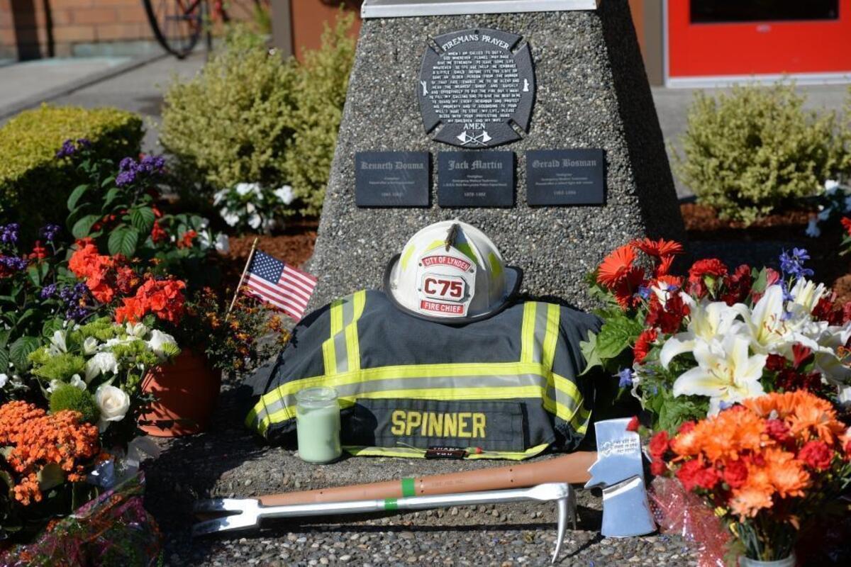 Chief Robert Spinner’s turnout gear and white Chief 75 helmet have been placed in a ceremonial position at the base of the flagpole outside Lynden Fire’s downtown Station 75. Alongside is a set of “irons,” firefighting tools that include a flathead ax and a Halligan bar.