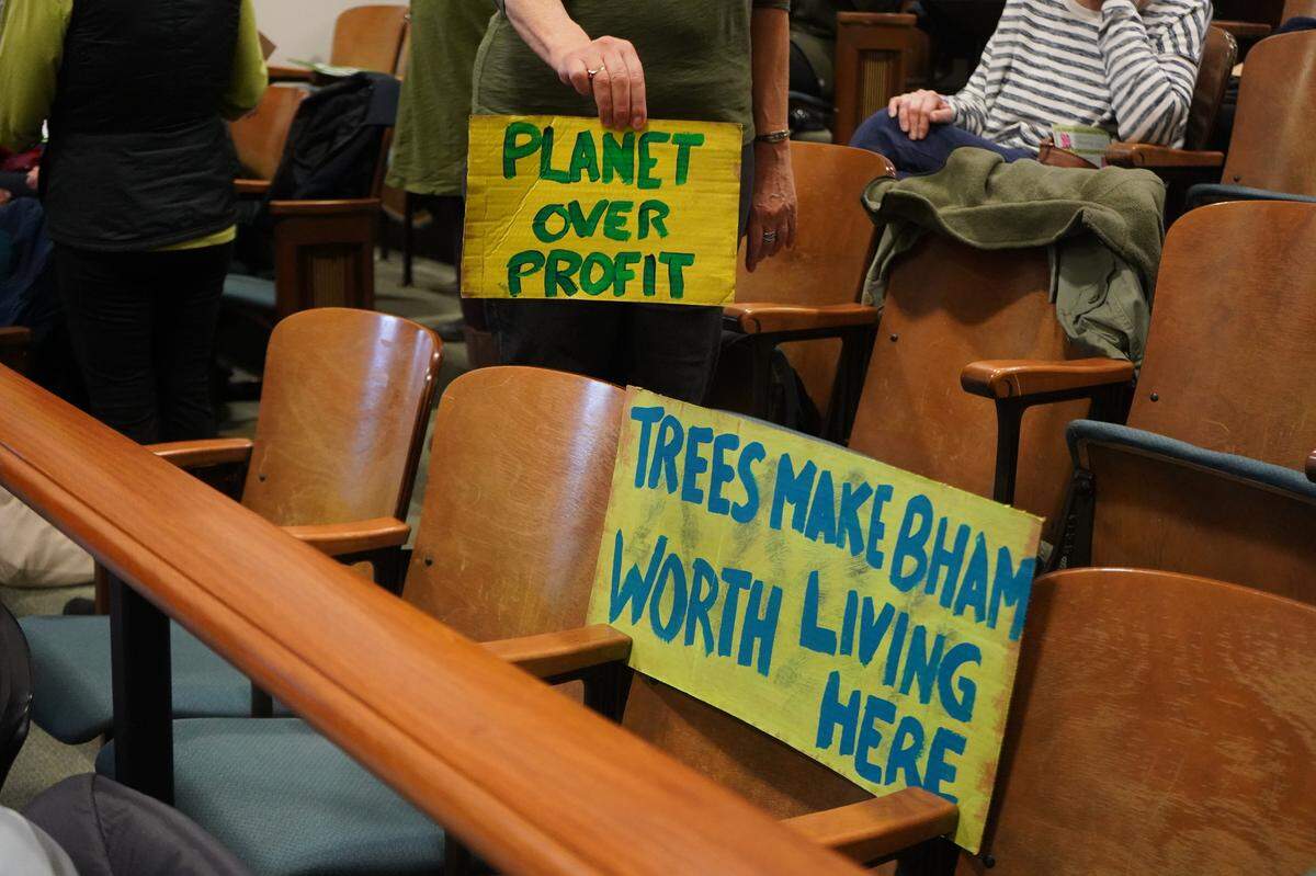 About 50 people filled a Hearing Examiner meeting on Wednesday, March 13, 2024, to express concern about the proposed loss of more than 300 trees at the hands of a proposed infill townhome development in Bellingham, Wash. They held signs saying, ‘Planet over Profit,’ and ‘Trees make Bham worth living here.’