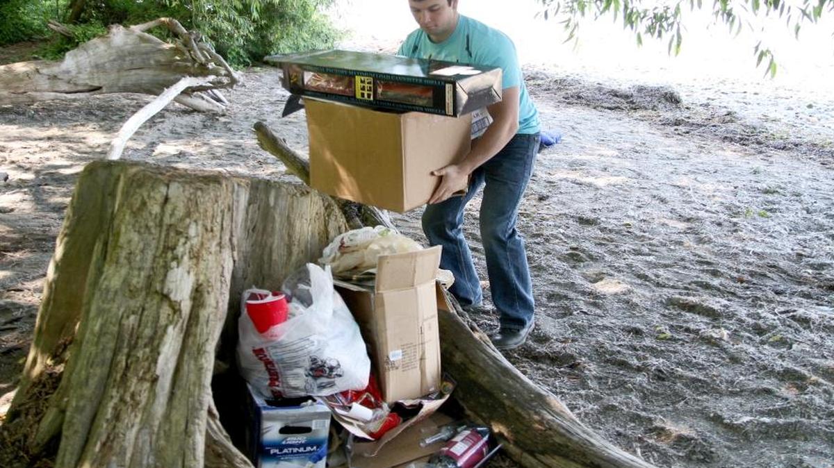 Surfrider Foundation volunteer Brett Warwick cleans up trash off Locust Beach in Bellingham, from Fourth of July festivities in 2012. Surfrider sponsors a benefit on Feb. 25 at Aslan Brewing Company.