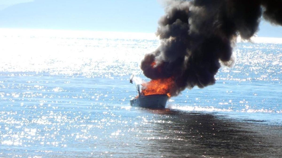 Two people were injured in a boat fire off Sandy Point on Wednesday, August 10. “It was pretty scary hearing the boaters yell help and nothing we could do from shore,” said Jennifer Snyder, who provided this photo. “We were relieved that other boaters also saw the explosion and came to their aid while we called 911.”