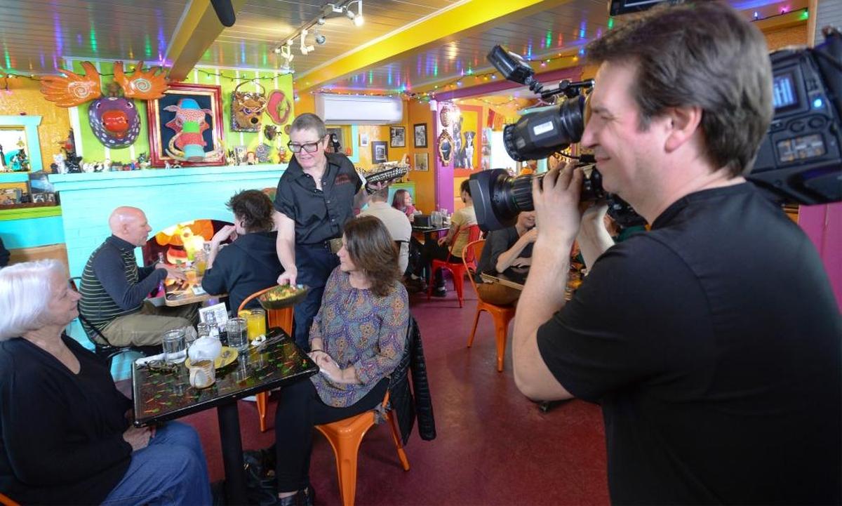 Homeskillet co-owner Tina White serves lunch to her mother-in-law Nancy White, left, and sister-in-law Nancy Edwards while cameraman Steve Lindsay films them for an episode of the Food Network Canada show ”You Gotta Eat Here!” at the restaurant in Bellingham in 2016.