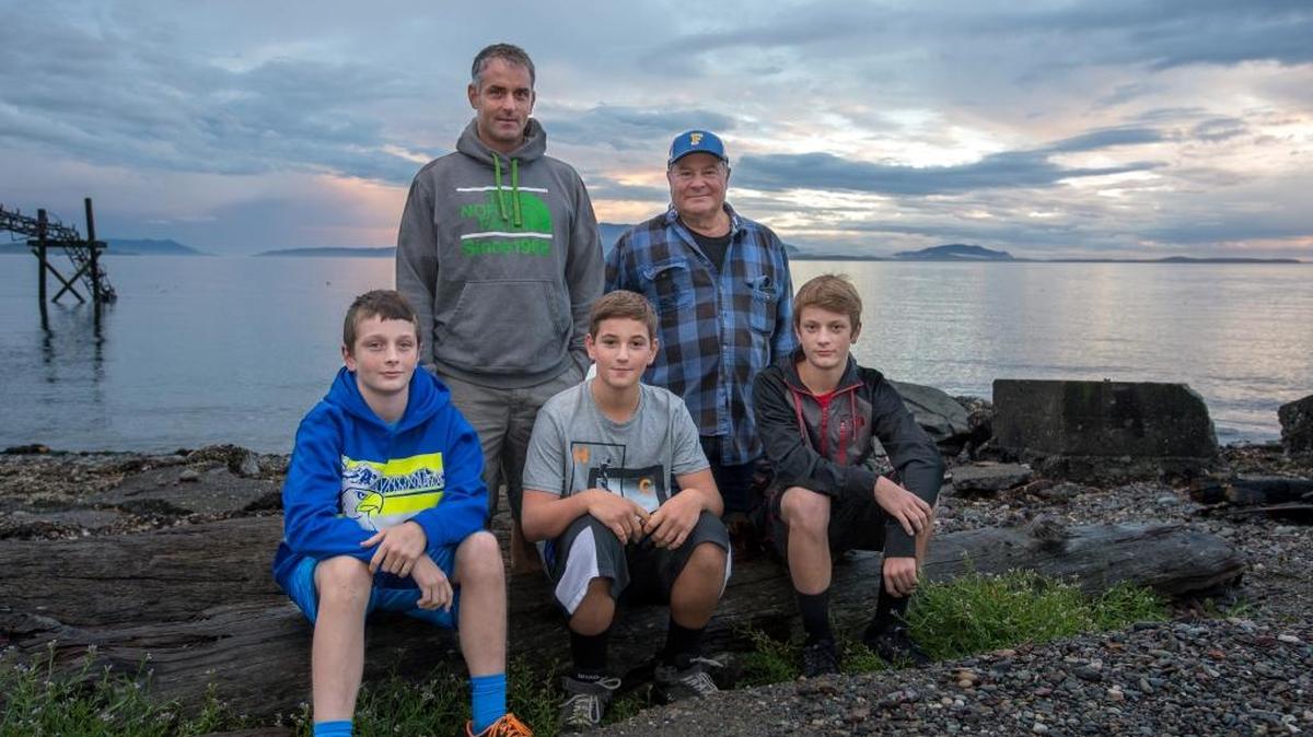 
Jacob Broselle, Tom Broselle, Aiden Peterson, Michael Peterson and Thomas Broselle (pictured left to right) stand on the shore Thursday, Sept. 3, near Ferndale. Tom and his sons Jacob and Thomas rescued Michael, Aiden and other members of the Peterson family after their boat capsized Aug. 28 about 500 yards out from Cherry Point.
