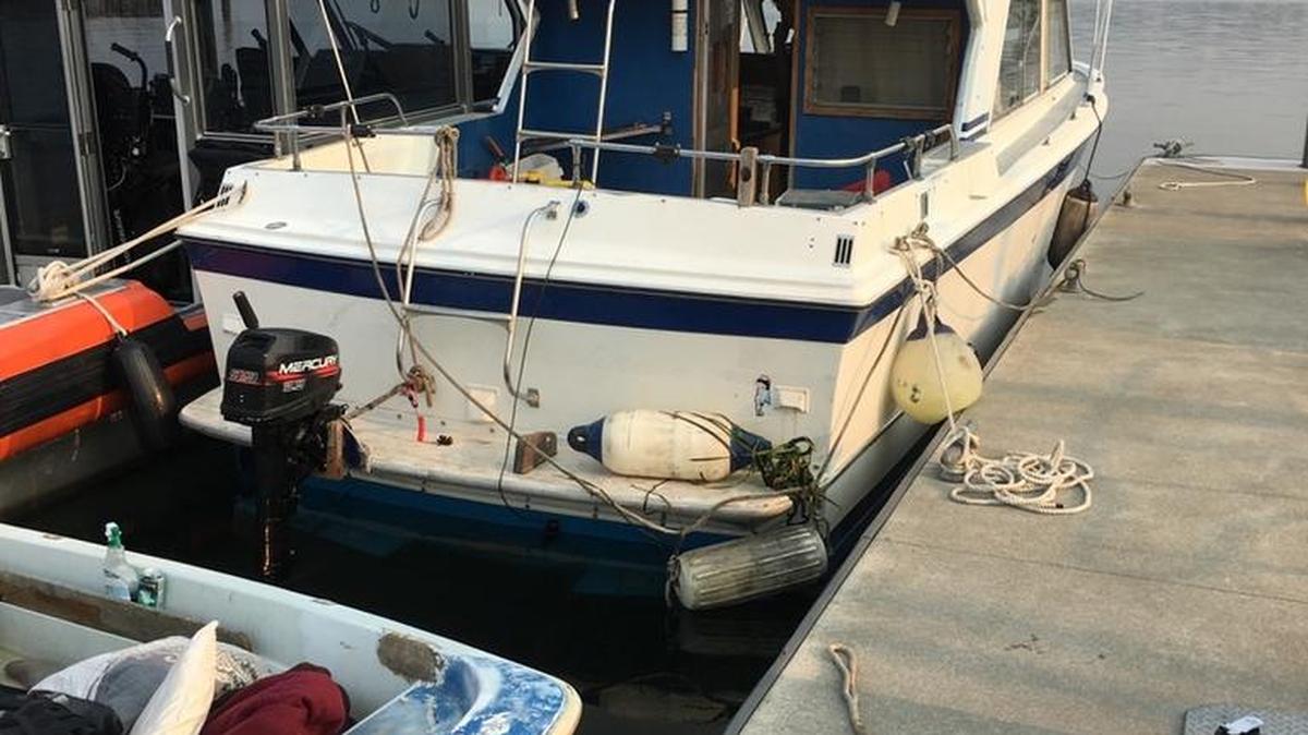 A 32-foot cabin cruiser sits at a dock near Anacortes, Wash., after a Coast Guard boarding team discovered a distributable amount of prescription pills, amphetamines and cash on the recreational vessel during a routine safety boarding of the boat, Aug. 9, 2017.