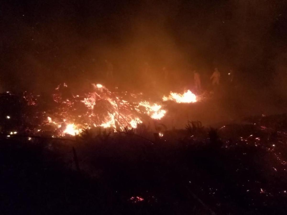 Fire crews scout the fire’s advance overnight Sunday in logging slash on state Department of Natural Resources land on Sumas Mountain.