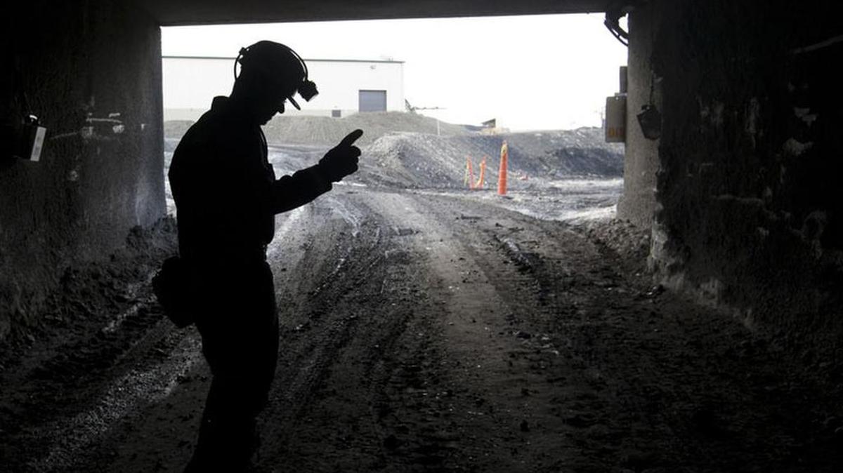 FILE - In this Nov. 9, 2010 photo, a mine employee stands in the entry of the Signal Peak Energy's Bull Mountain mine in Roundup, Mont.