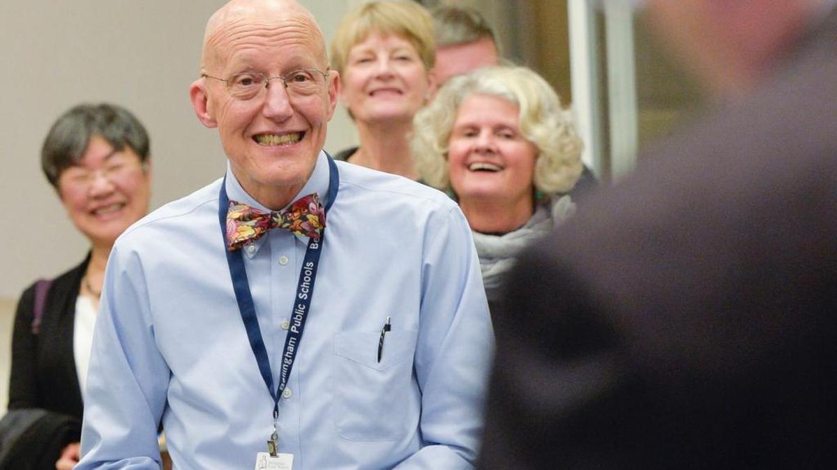 Bellingham School Board member Dr. Ken Gass listens to Superintendent Greg Baker’s speech honoring him during a retirement party for Gass on Nov. 16, 2015, at the school district office. Gass, a pediatrician, served 17 years on the school board.