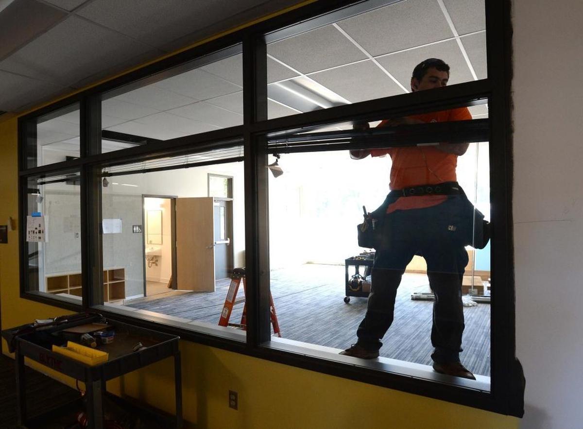 Patrick Daniels installs window blinds in the new Fisher Elementary School on Aug. 22, 2017, in Lynden. Bellingham has a higher proportion of jobs in construction, manufacturing and sales compared to other vocations, according to a new report.