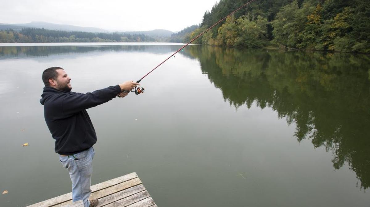 Tony Murray was traveling the country from New Jersey when he stopped to fish at Lake Padden in Bellingham. on Oct. 8, 2014. Ecology officials say a bacterial bloom reported Thursday has made the lake unsafe for humans and pets until further notice.