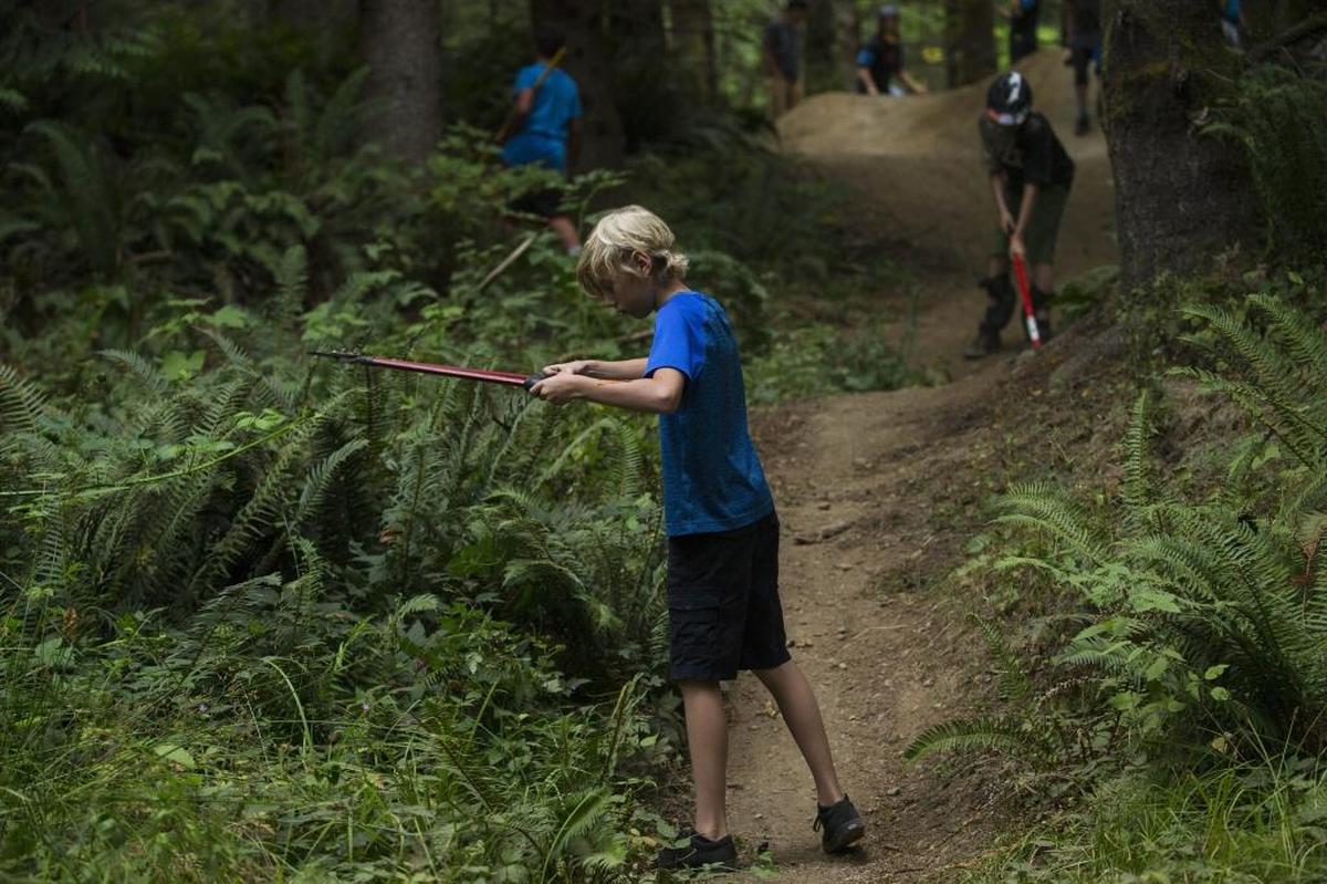 Riders work on maintaining mountain bike trails on Galbraith Mountain during a mountain bike camp in Bellingham, Wash., Aug. 10, 2016.