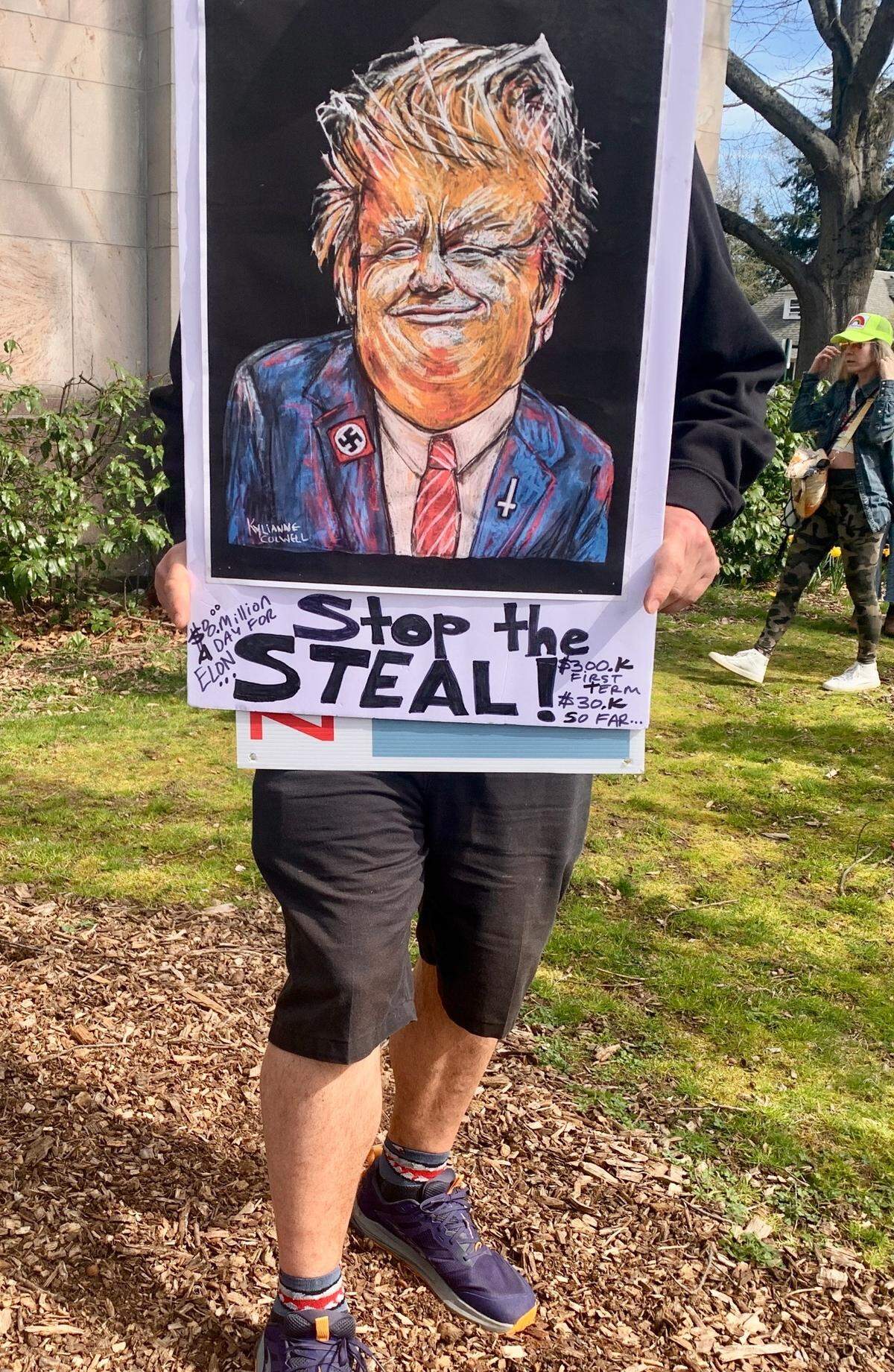 A protest participant displays a handmade anti-Trump sign Saturday at Bellingham City Hall.