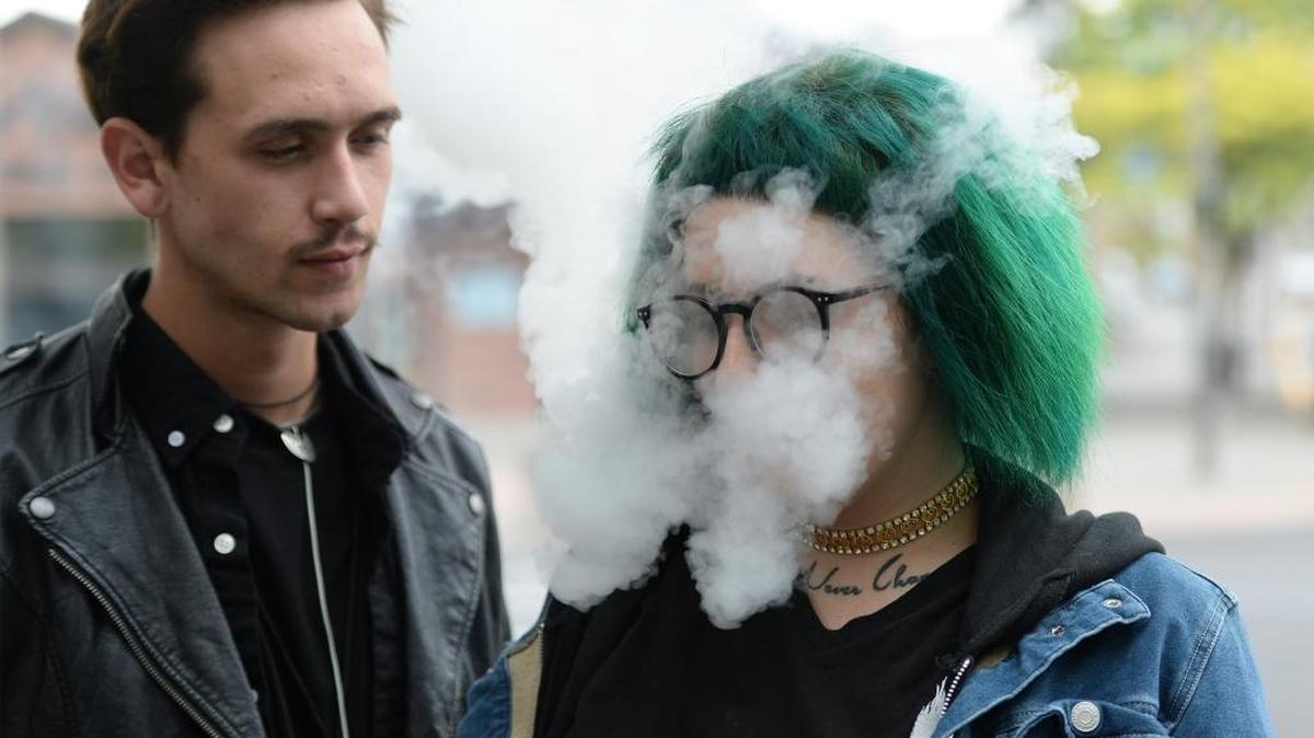 Cooper Lariviere, left, takes a break with his friend Bre Christy, who was vaping in downtown Bellingham Tuesday, Aug. 9, 2016.