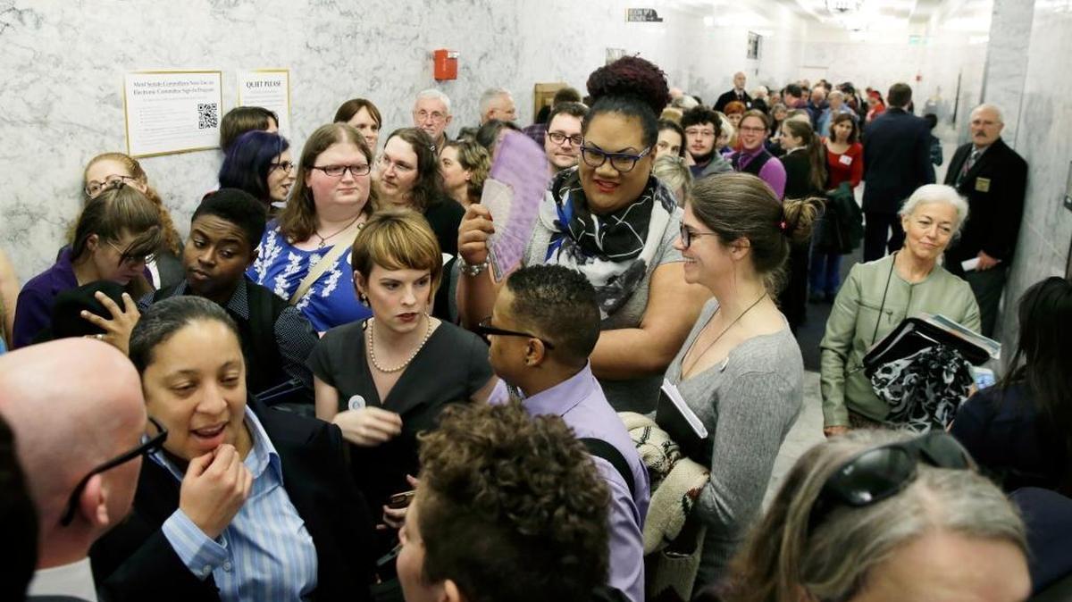 People pack a hallway outside a Washington Senate hearing room, Wednesday, Jan. 27, 2016, at the Capitol in Olympia, Wash., as they wait to listen to public testimony regarding a bill that would eliminate Washington’s new rule allowing transgender people use gender-segregated bathrooms and locker rooms in public buildings consistent with their gender identity.