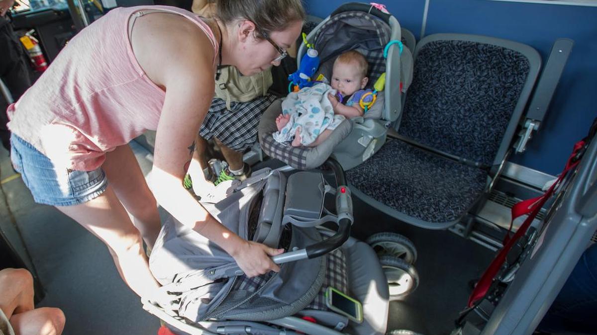 
Hannah Cassar boards a bus to Fairhaven with her son, Harrison Cassar, 5 months, at Whatcom Transportation Authority’s downtown station in Bellingham, Tuesday, Aug. 11, 2015. Hannah says the WTA requirement to take the baby out of the stroller and then collapse the stroller when she boards the bus is "like playing Twister," and she would prefer to keep the baby in the stroller.
