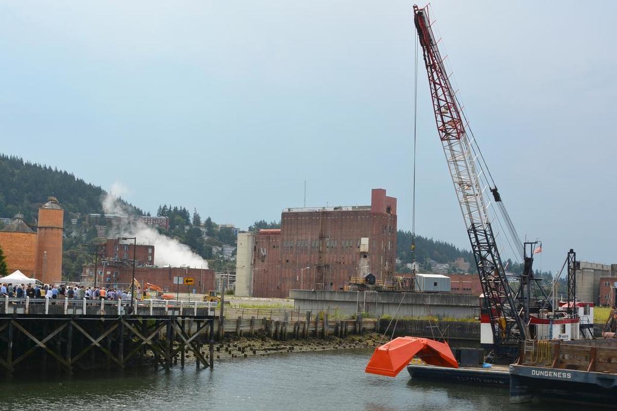 Local government employees gather to celebrate the beginning of cleanup work along Bellingham’s downtown waterfront Wednesday, Aug. 12. 