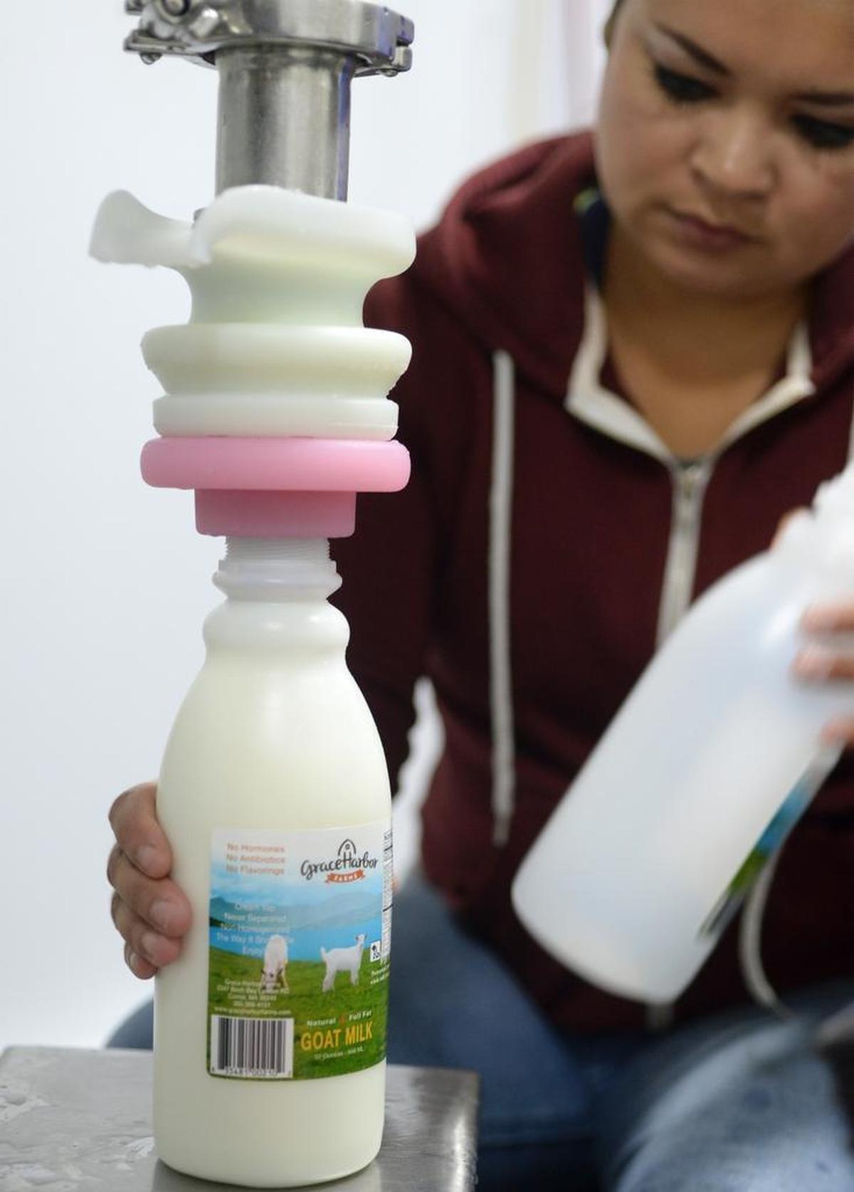 Christina Groen fills up a quart of goat milk at Grace Harbor Farms, west of Lynden on July 20.