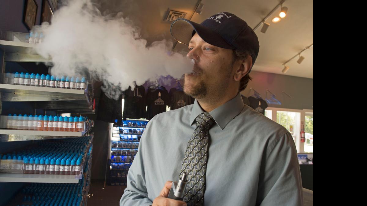 
Mt. Baker Vapor store manager Tim Lee vapes in the store south of Lynden on Wednesday, June 10, 2015. The company is moving its production facility to Arizona because of the possibility of new Washington state laws that would restrict online sales and impose new taxes on e-liquid. The store will remain in Whatcom County.
