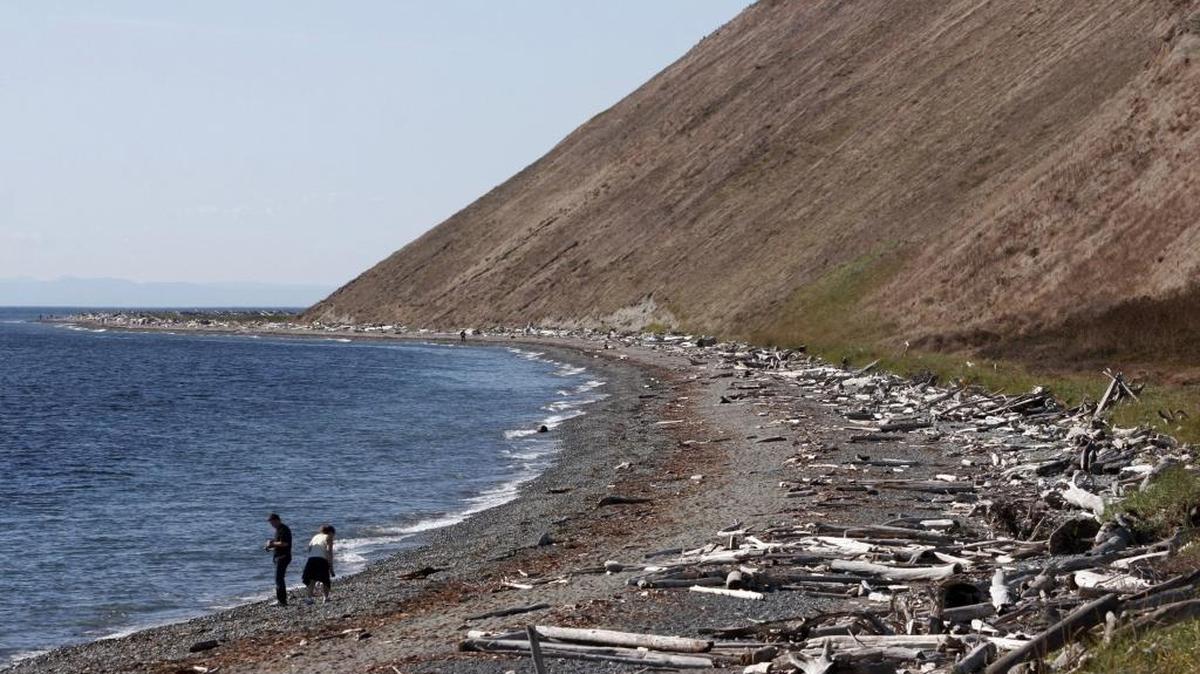 A couple walks along a beach at Ebey’s Landing National Historic Preserve on Whidbey Island. The federal spending bill passed Friday, Dec. 18, 2015, includes money to provide conservation easements to preserve historic farmland at the landing.
