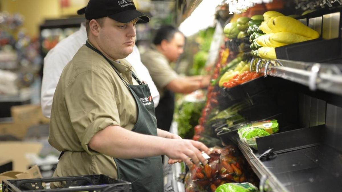 Assistant produce manager Tyrell Mortimer stocks produce on the shelves Feb. 4, 2015, at the new Bellingham Safeway store in Sunset Square. Safeway will be open regular hours on Thanksgiving for those needing last-minute items.
