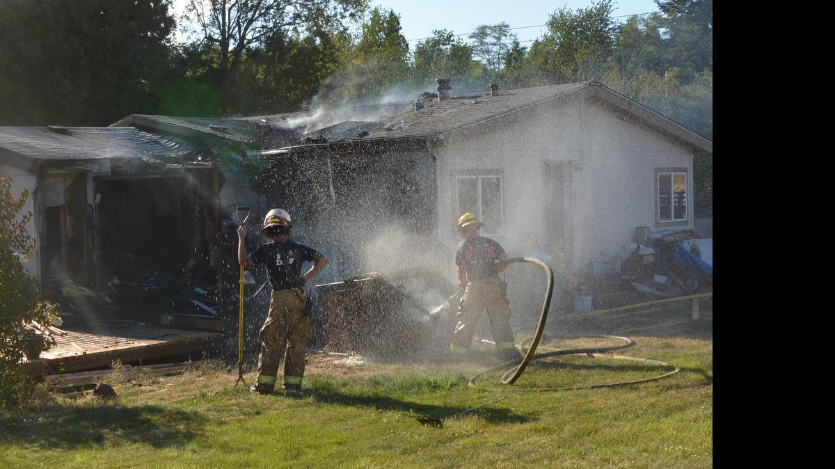 
Firefighters battle a house fire Monday evening, June 29, on Yukon Way. Flames destroyed most of the home’s southeast corner, and left severe smoke damage throughout the home.

